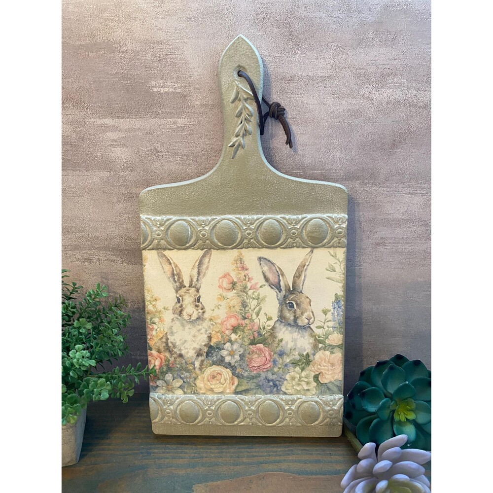 Decorative cutting board for display. Molds castings and bunnies in a floral fie